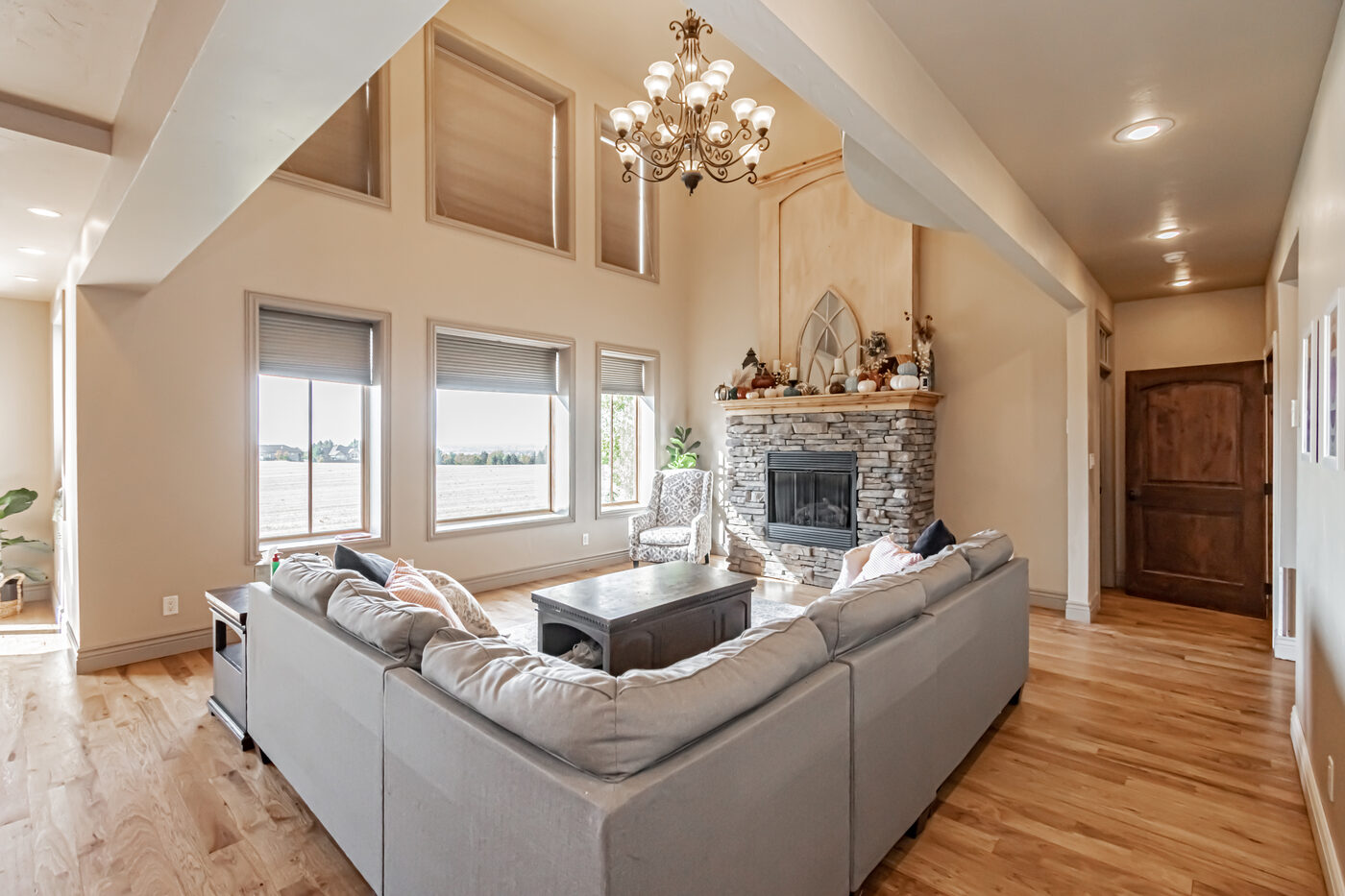 Living room with stone fireplace and vaulted ceiling